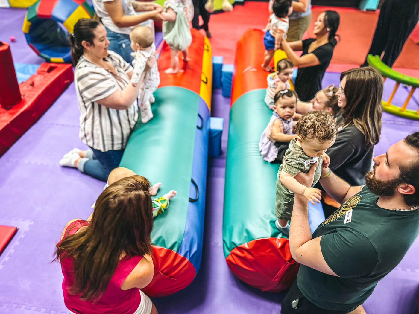 A group of parent and children enjoying Romp n' Roll Wethersfield's gym, review our frequently asked questions at Romp n' Roll Wethersfield.