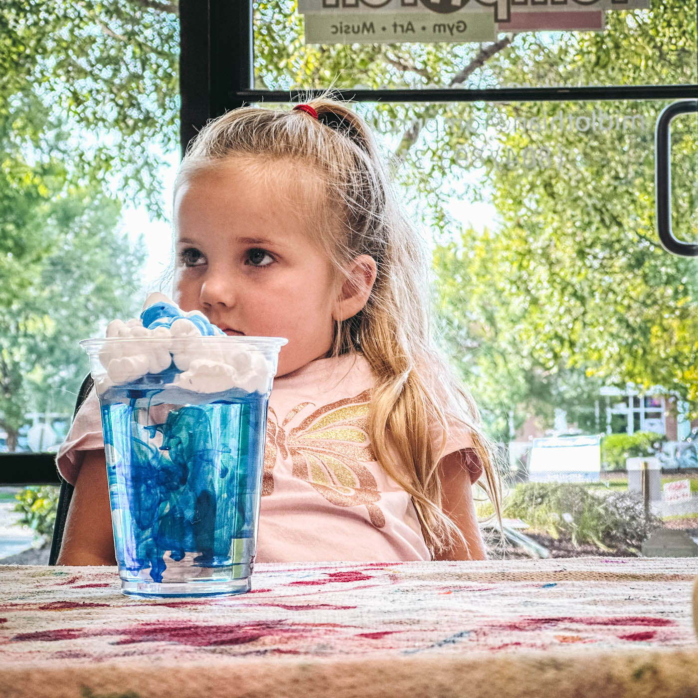 A little girl enjoying a blue drink, sign up for our affordable summer camps in Glen Allen, VA.