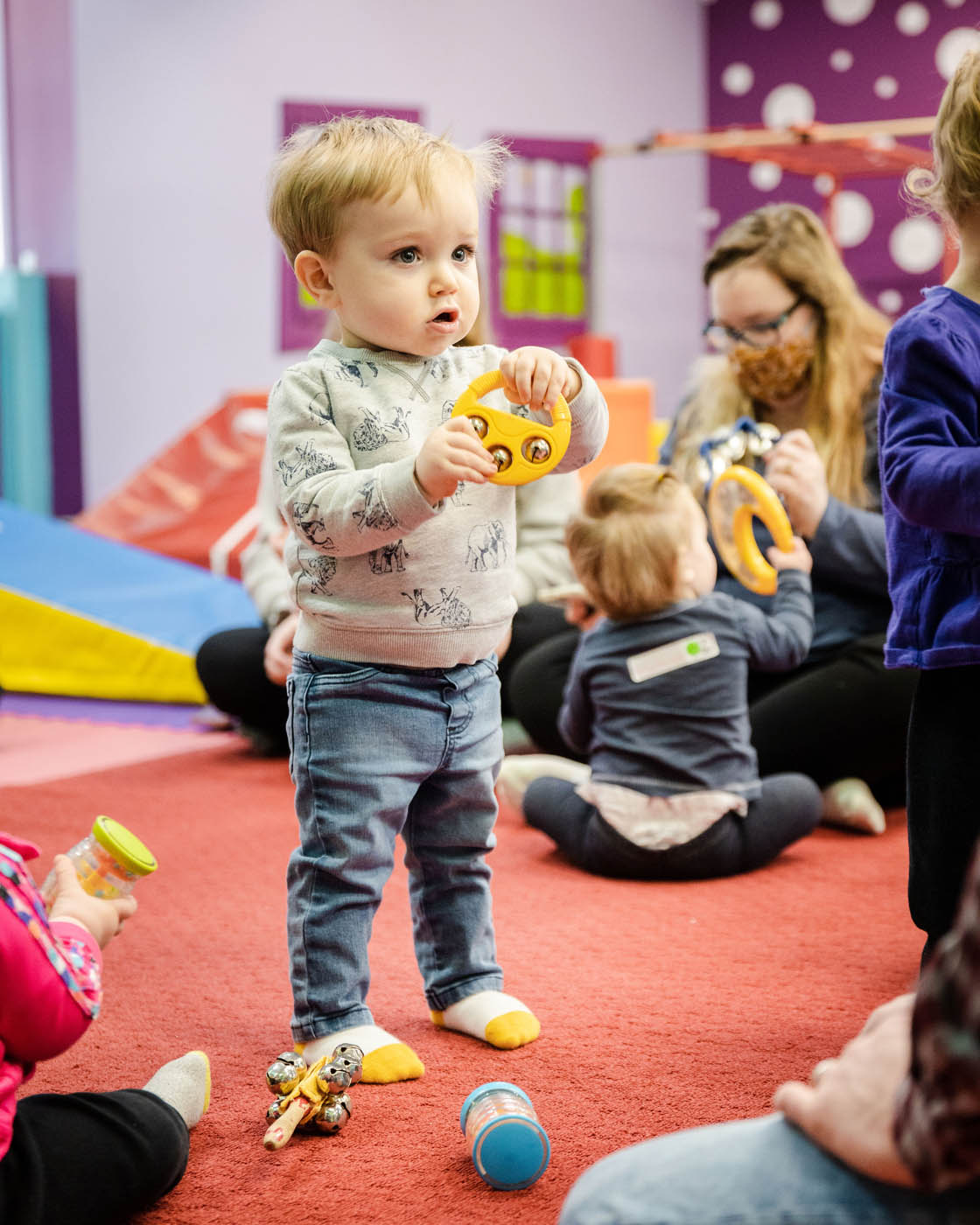 A boy enjoying the wonders of music at a baby music class offerd by Romp n' Roll.