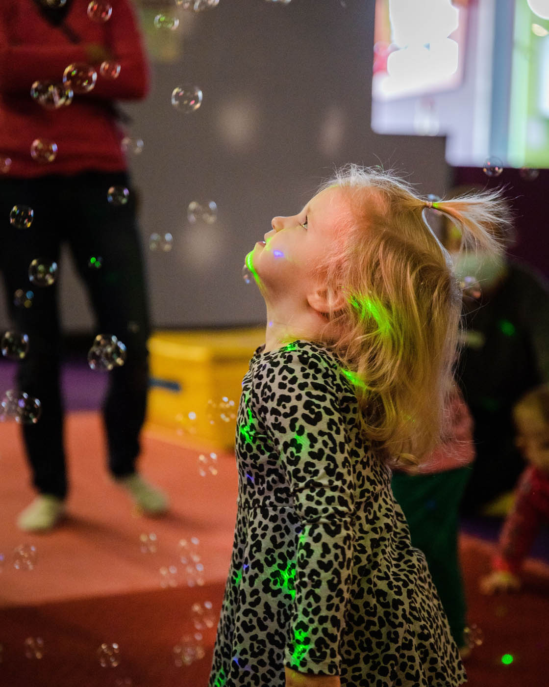 A little girl enjoying classes with bubbles at Romp n' Roll in Willow Grove. 