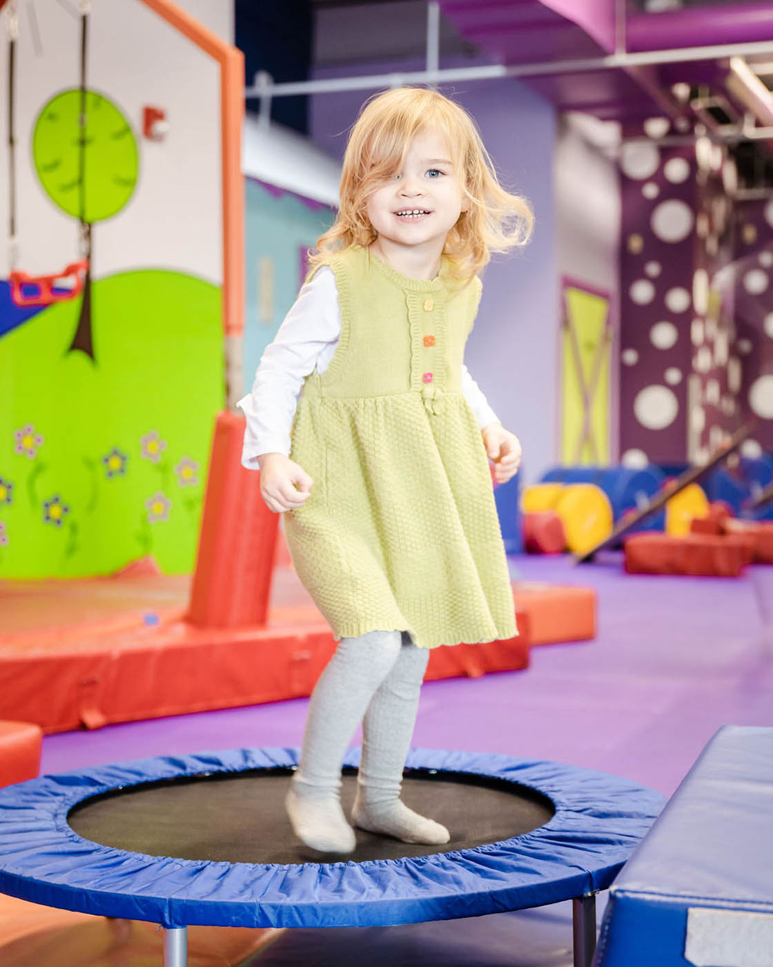 Little girl jumping on a tramp in Romp n' Roll's, contact us for toddler classes.