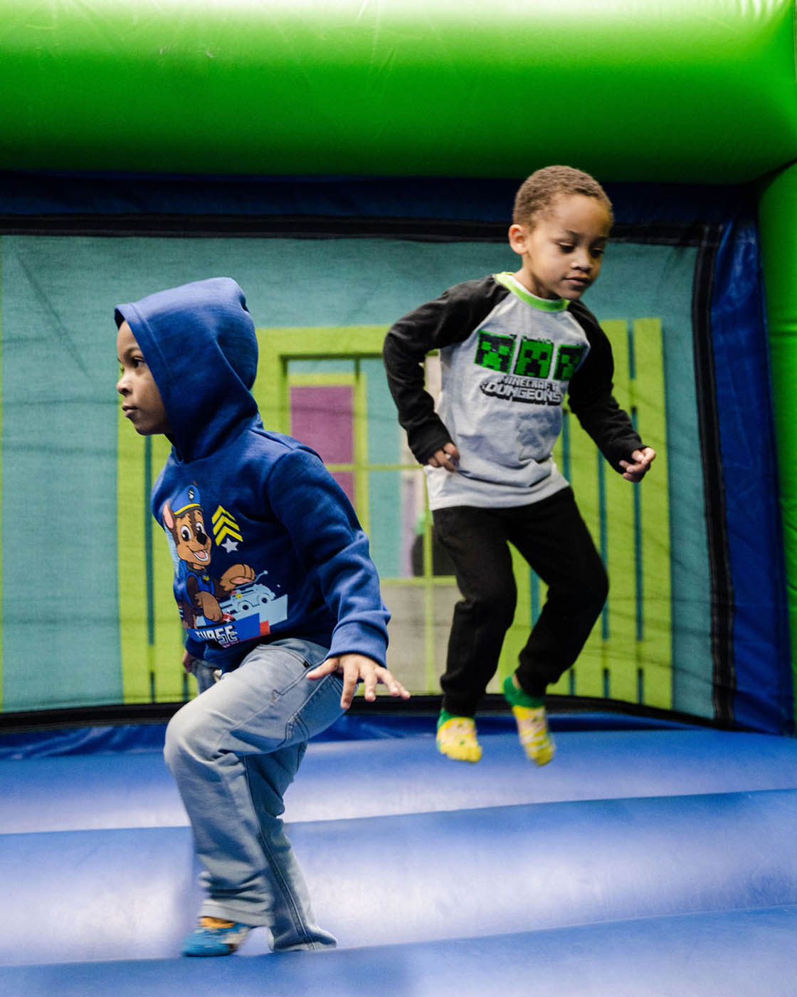 Two boys playing together at a Romp n' Roll gym in Willow Grove.
