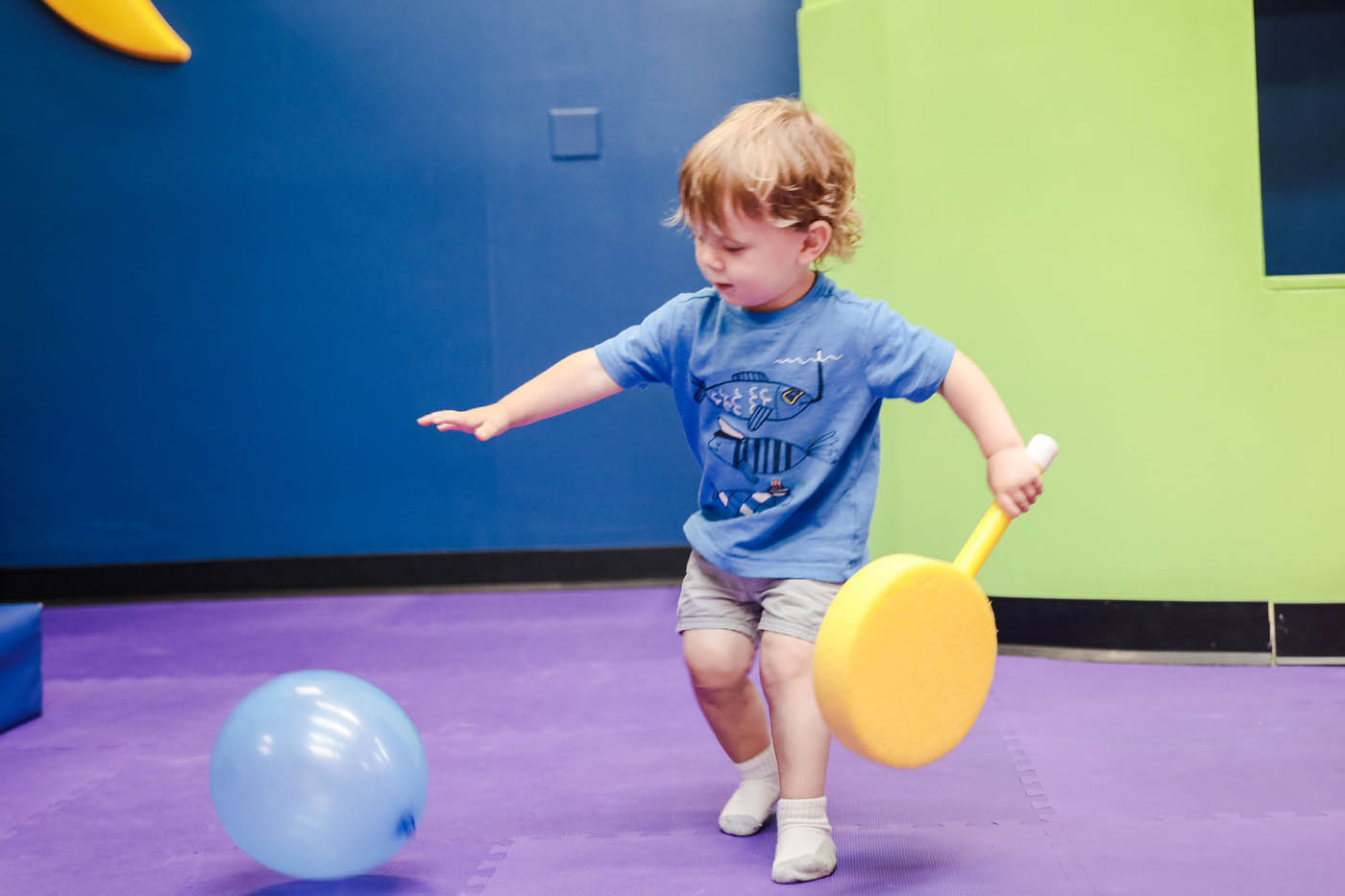 A toddler playing with a balloon at Romp n' Roll Willow Grove's classes for 2 year olds in Willow Grove, PA