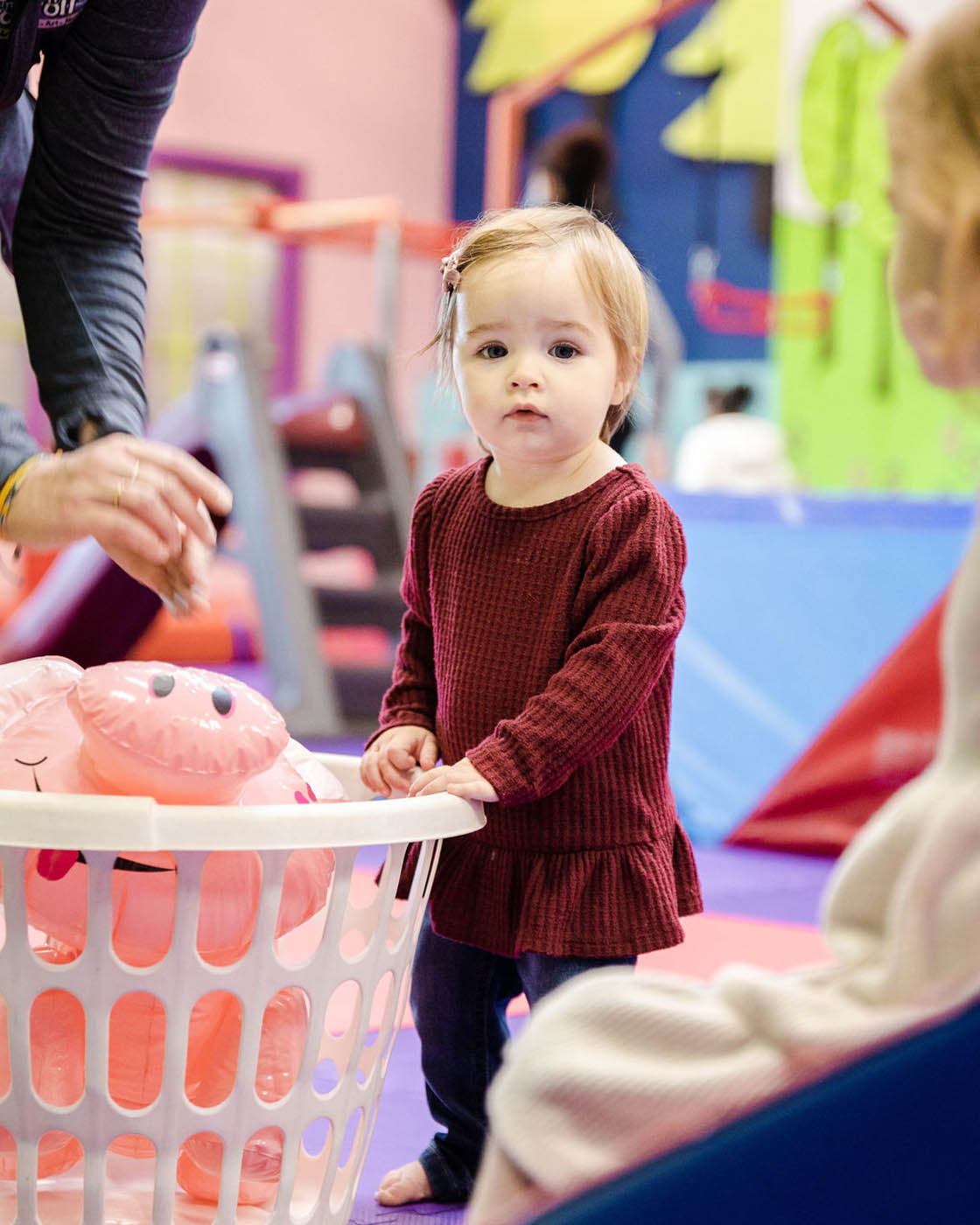 A girl enjoying the toys you can play with at Romp n' Roll in Raleigh.